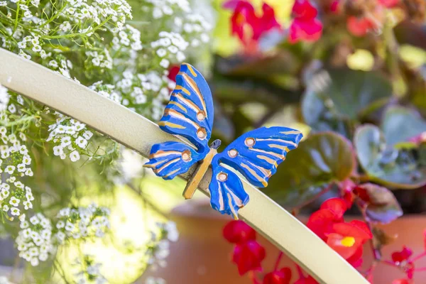 Garden decor for flower beds. Blue metal butterfly park decoration.
