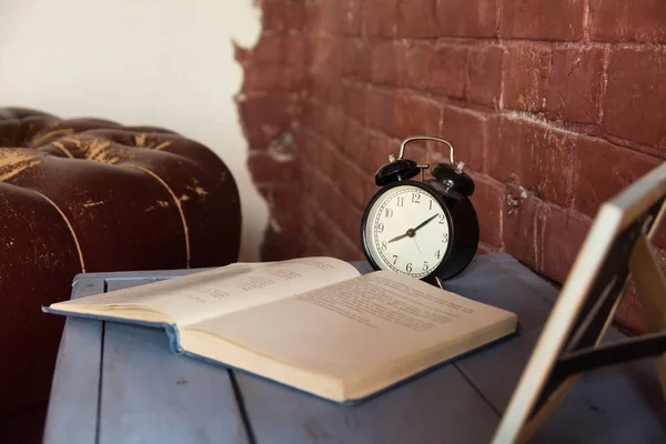 Desk Clock Open Book Wooden Table Brick Wall Background — Stock Photo, Image