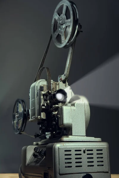 Cinema projector with a film on a dark background.