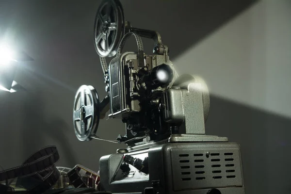 Cinema projector with a film on a dark background.