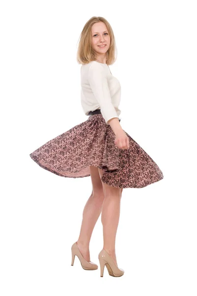 Portrait of a young woman with a skirt circling in full growth isolated over a white — Stock Photo, Image