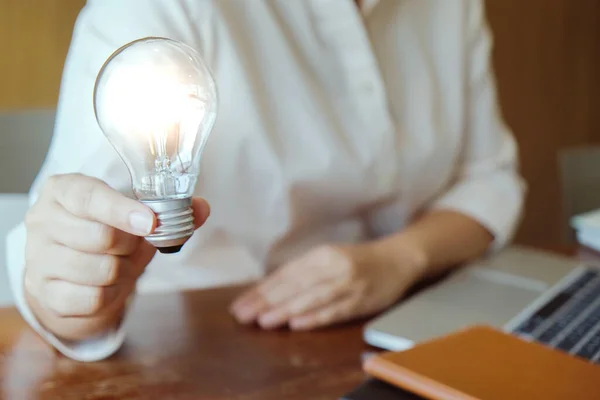 Idea of business person holding light bulb concept creativity with bulbs