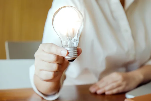 Idea of business person holding light bulb concept creativity with bulbs