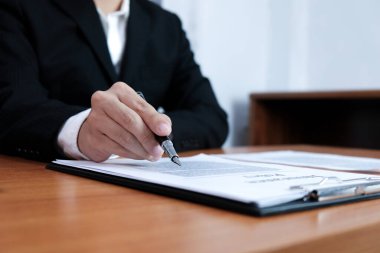 Satış müdürü, araba ve ev sigortası için ipotek kredisi teklifini göz önünde bulundurarak, tavsiye başvuru formu belgesi veriyor