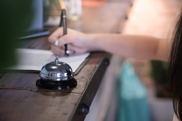 woman guest at the reception of  hotel checking in