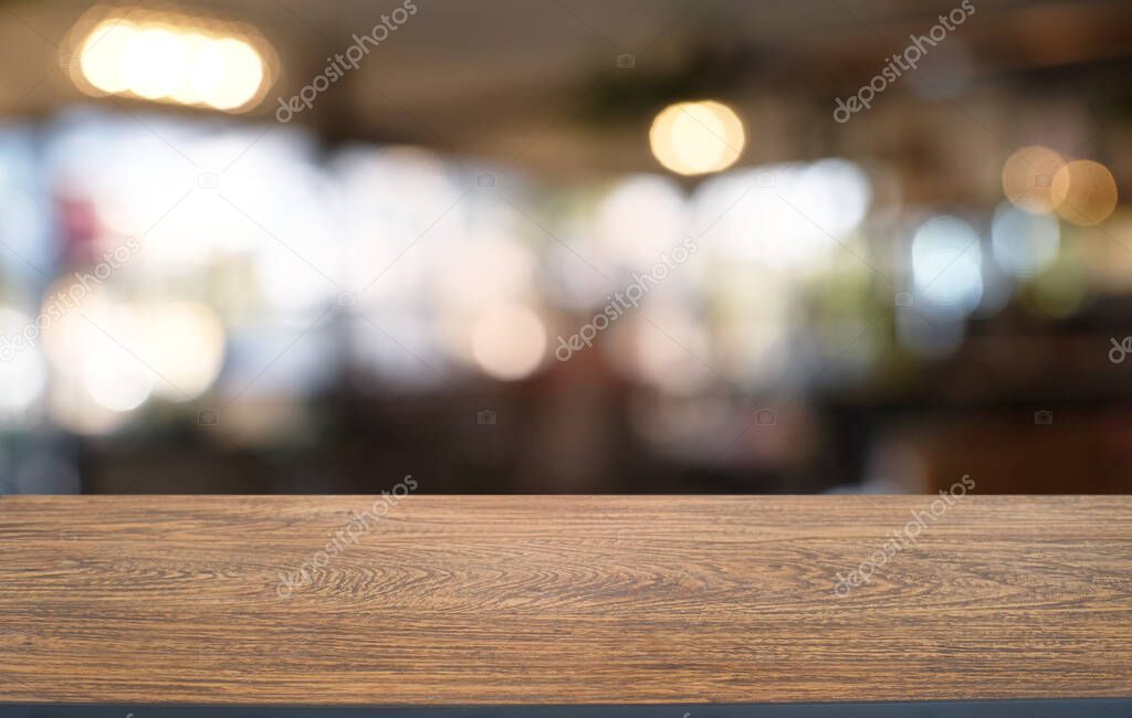 Empty dark wooden table in front of abstract blurred bokeh background of restaurant . can be used for display or montage your products.Mock up for space