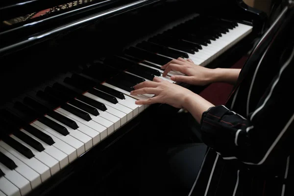 Beautiful woman playing piano, learn to play piano