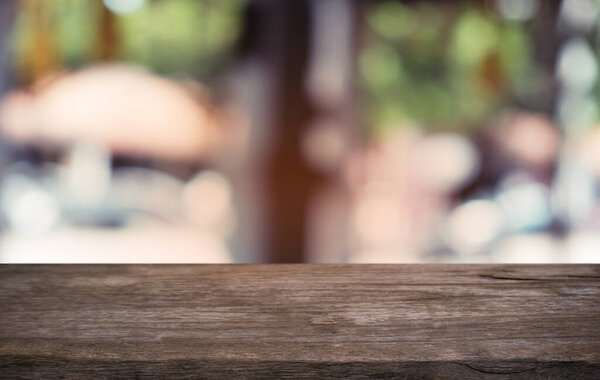 Empty dark wooden table in front of abstract blurred bokeh background of restaurant . can be used for display or montage your products.Mock up for space