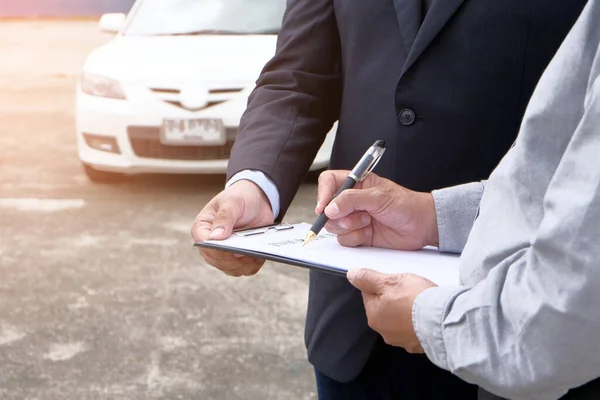 Loss Adjuster Insurance Agent Inspecting Damaged Car