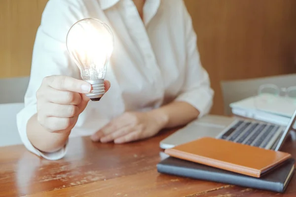 Idea of business person holding light bulb concept creativity with bulbs