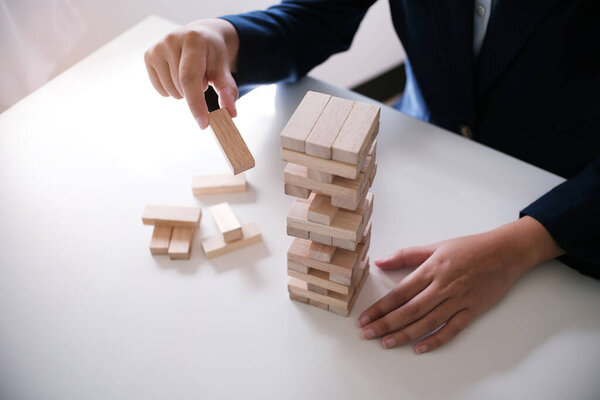 Planning risk and strategy in businessman gambling placing wooden block.Business concept for growth success process.