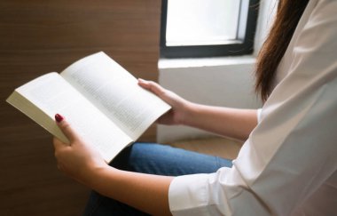 Kitap okuyan ve kütüphanede dinlenen kadınlar. seçici odak.