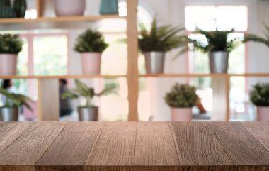 Restoranın soyut bulanık arka planının önündeki boş, siyah ahşap masa. Ürünlerinizi görüntülemek ya da montajlamak için kullanılabilir. 