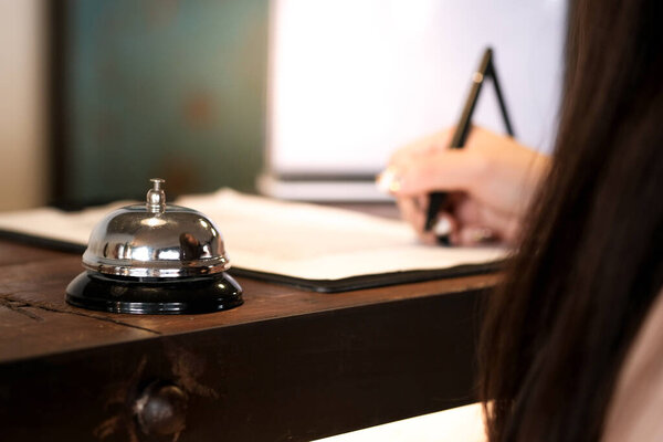 woman guest at the reception of  hotel checking in