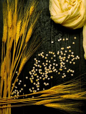 dikey bileşim sarı eşarp, pasta yıldızları ve buğday kulaklarıyla kara tahta, arkaplan