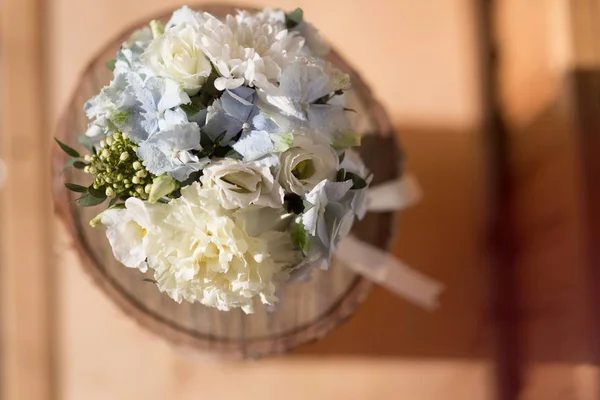 Different flowers in a box on the table, round composition, beautiful gift