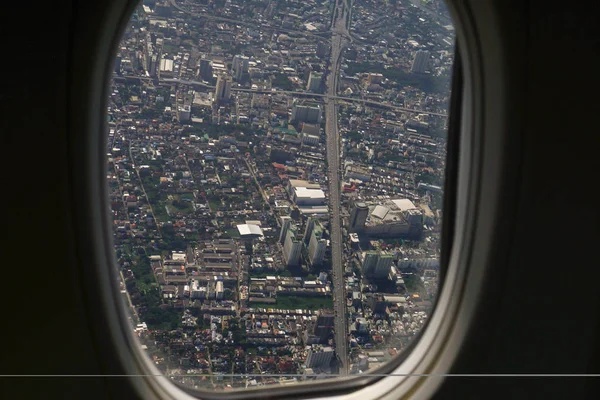 Image of plane window View of the village from the bird\'s eye view, Bangkok City, Thailand