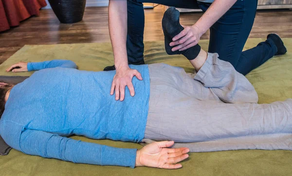 Shiatsu massage on the floor with hands, back and feet