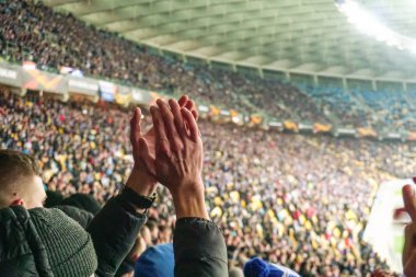 Onların takım destekleyen büyük kalabalık futbol taraftarları eller, alkışlar. Sporseverler Stadyumu'nda, ağır çekim oyunu izlerken, kalabalık