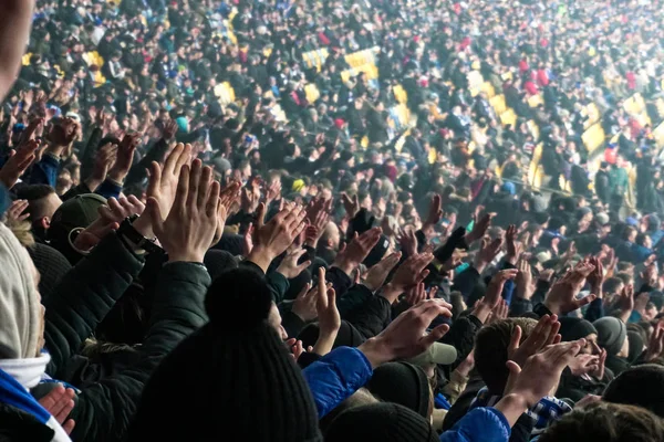 Grote menigte van de ventilators van de voetbal klappen handen, ter ondersteuning van hun team. Menigte van sportfans kijken naar spel stadium, slow-motion — Stockfoto