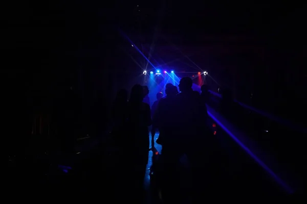 Dav lidí tančí pod disco laserové světlo — Stock fotografie