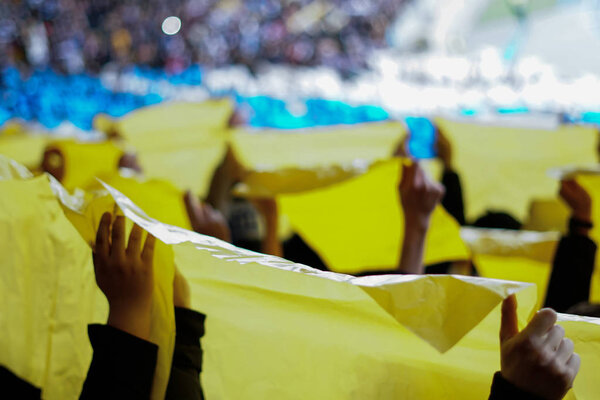 hands up with colored posters