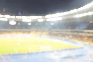 Alacakaranlık vakti, soyut arka plan kullanımı için futbol stadyumunun bulanık görüntüsü.