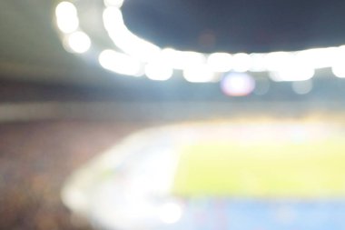 Alacakaranlık vakti, soyut arka plan kullanımı için futbol stadyumunun bulanık görüntüsü.