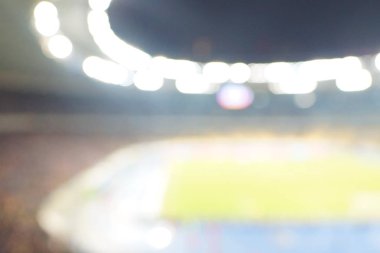 Alacakaranlık vakti, soyut arka plan kullanımı için futbol stadyumunun bulanık görüntüsü.