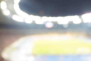 Alacakaranlık vakti, soyut arka plan kullanımı için futbol stadyumunun bulanık görüntüsü.