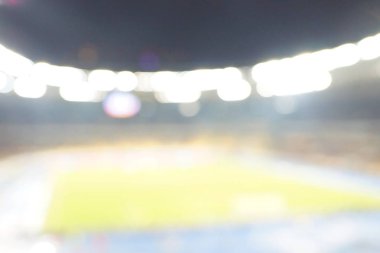 Alacakaranlık vakti, soyut arka plan kullanımı için futbol stadyumunun bulanık görüntüsü.