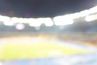 Alacakaranlık vakti, soyut arka plan kullanımı için futbol stadyumunun bulanık görüntüsü.