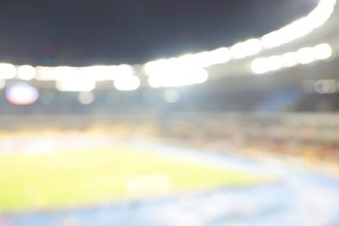Alacakaranlık vakti, soyut arka plan kullanımı için futbol stadyumunun bulanık görüntüsü.