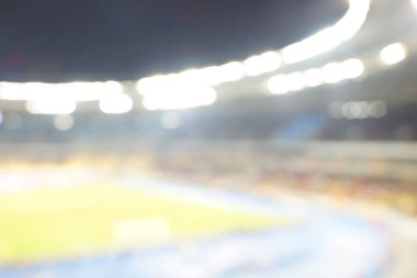 Alacakaranlık vakti, soyut arka plan kullanımı için futbol stadyumunun bulanık görüntüsü.