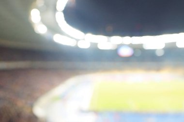 Alacakaranlık vakti, soyut arka plan kullanımı için futbol stadyumunun bulanık görüntüsü.
