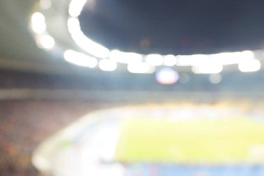 Alacakaranlık vakti, soyut arka plan kullanımı için futbol stadyumunun bulanık görüntüsü.