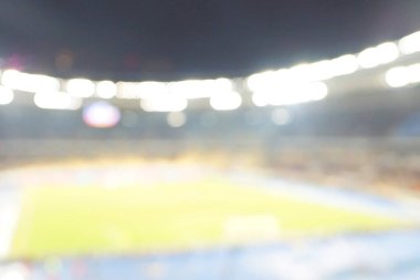 Alacakaranlık vakti, soyut arka plan kullanımı için futbol stadyumunun bulanık görüntüsü.