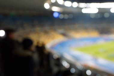 Alacakaranlık vakti, soyut arka plan kullanımı için futbol stadyumunun bulanık görüntüsü.