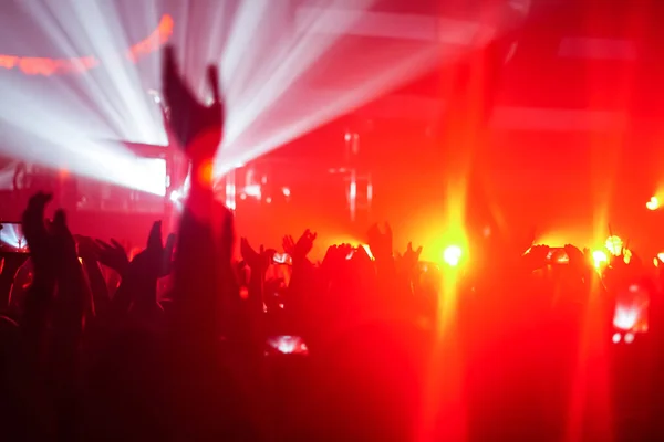 Silhuetas de multidão de concerto na frente de luzes de palco brilhantes — Fotografia de Stock