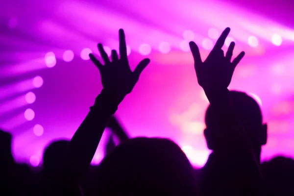 Silhuetas de multidão de concerto na frente de luzes de palco brilhantes — Fotografia de Stock