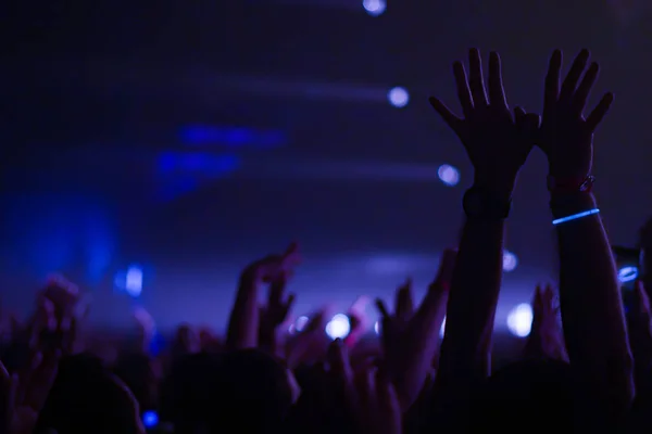 Silhuetas de multidão de concertos em frente a luzes de palco brilhantes. Conceito de vida noturna e festa de concerto . — Fotografia de Stock