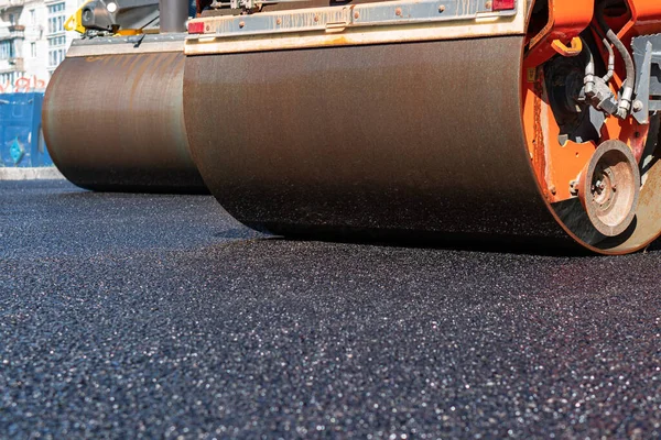 Buharlı silindir, asfalt katranı düzleştirmiş.