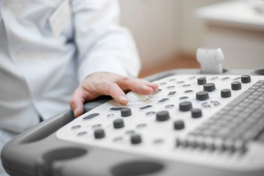 Doktor hastaya ultrason uyguluyor, bir el yakın