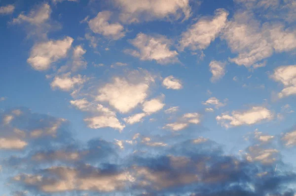 White and black clouds against the blue sky. Image for background.