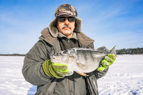 Fisherman catch on winter fishing — Stock Photo, Image