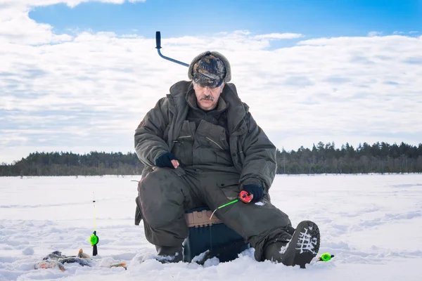 Fisherman catch on winter fishing — Stock Photo, Image