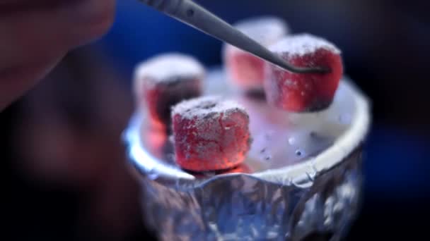 Coconut coals on aluminum foil on hookah Cup close up selective focus. withers away on top of a bowl of sheesha — Stock Video