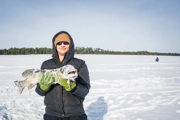 Fisherman catch on winter fishing — Stock Photo, Image