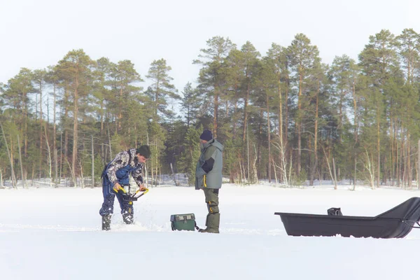 冬の釣りドリル穴の氷のドリルの男 — ストック写真