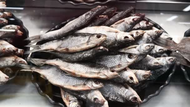 Dried fish roach, Rudd. lies on the counter in the market, salty snacks. roach — Stock Video